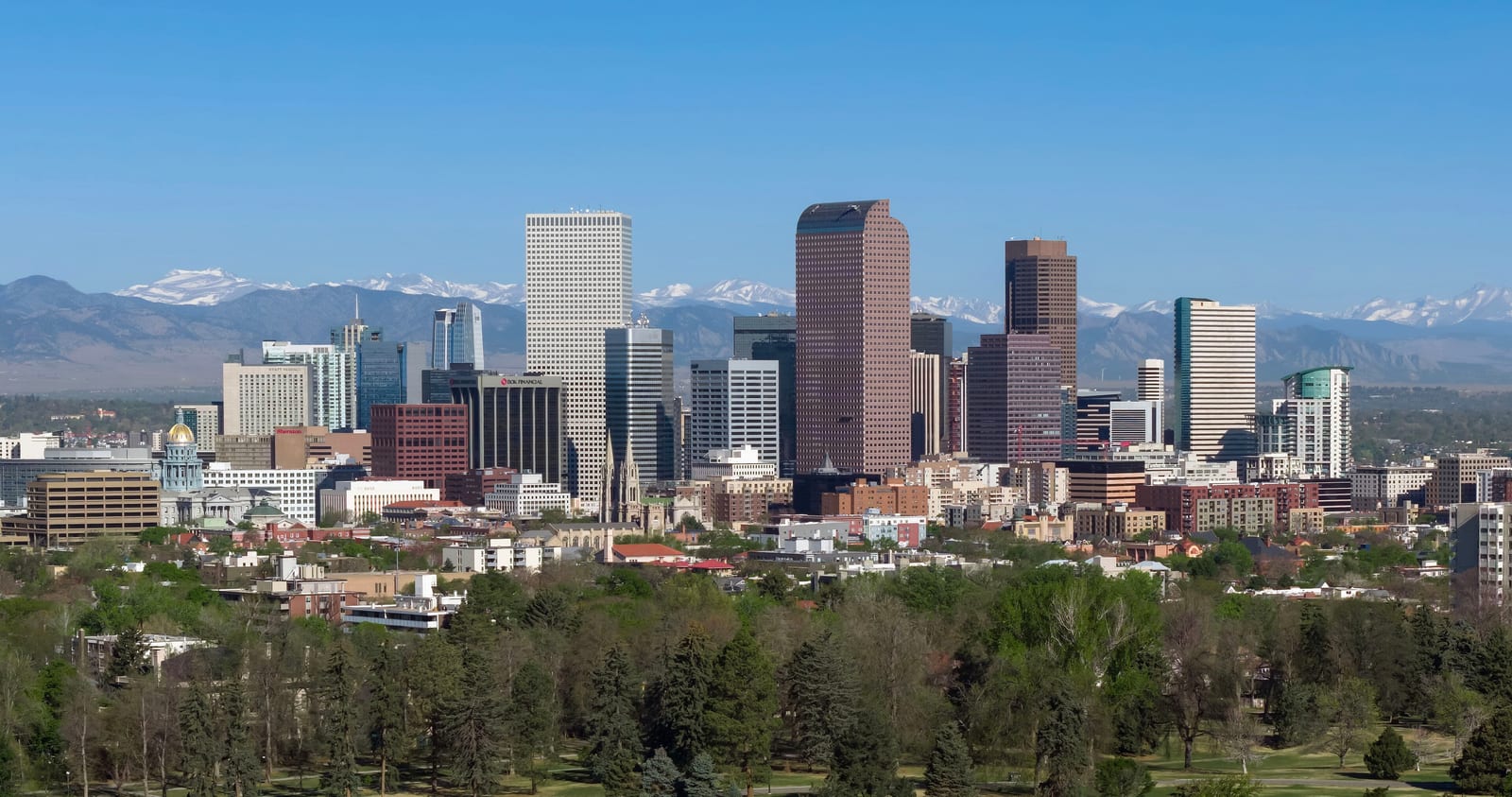 Denver skyline with the snow-capped Front Range rising behind City Park